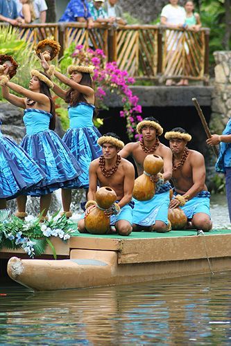 a group of people in blue dresses on a boat