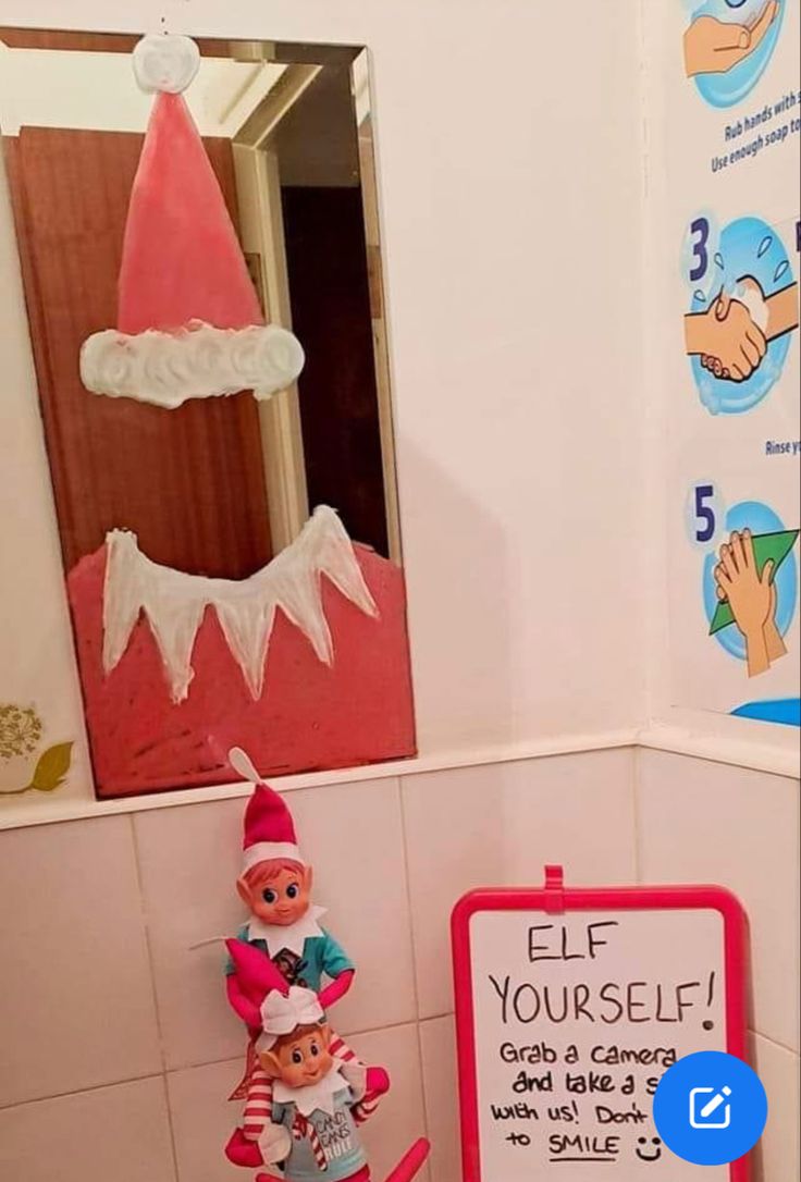 the elf in the bathroom is next to a sign