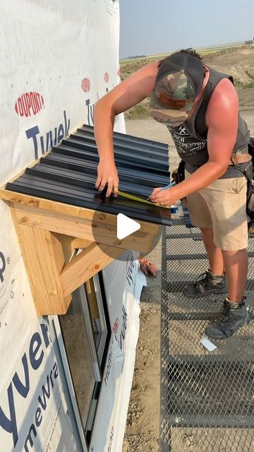 a man working on an outdoor project with a hammer and some sort of roofing material