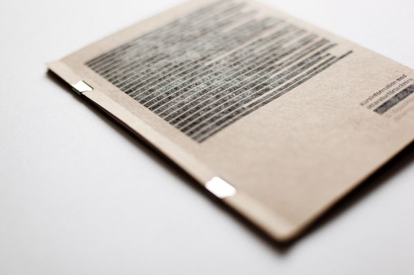 an open book with some type of text on the front and back cover, sitting on a white surface