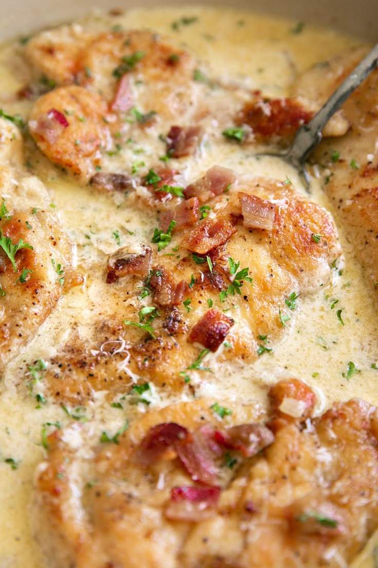 a close up of a bowl of food with meat and cheese in it on a table