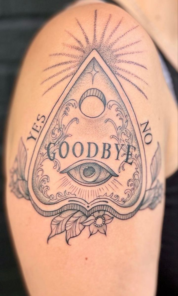 a woman's arm with an all seeing triangle and the words goodbye on it