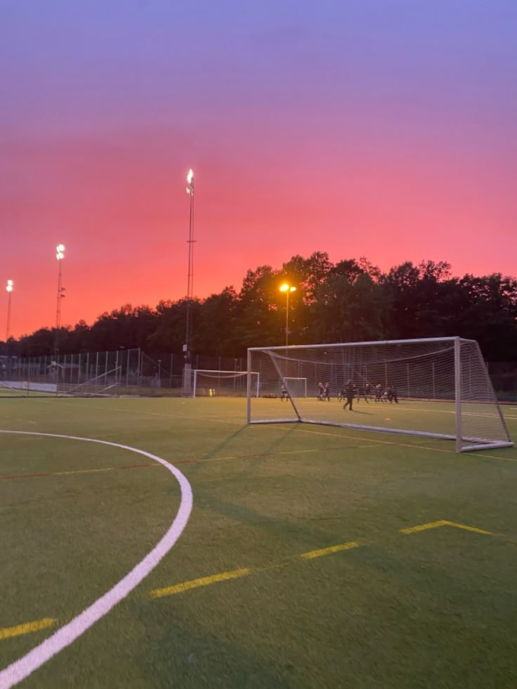 soccer field with goal and lights at dusk