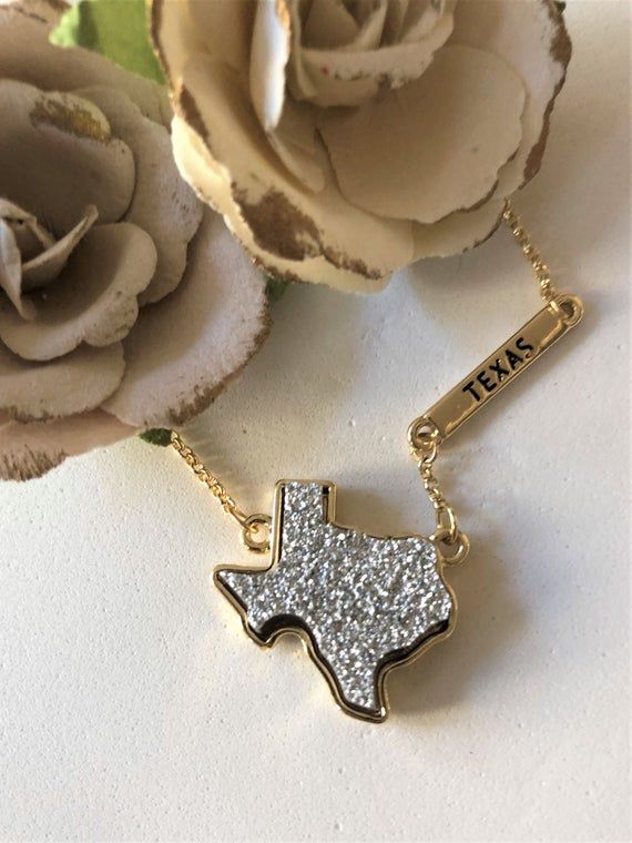 Custom designed by Alicia's Precious Collection.  Handmade with love, in Spring, TX. Gold Texas State Shaped Necklace, Silver Druzy Stone and Gold Engraved Texas Bar from the Lone Star State.16" dainty Gold chain adjustable to 18".You will love this little cutie...Packaging includes a beautiful glass jar with cork top. 10% of profits will be donated to Anxiety and Panic Disorder Foundations in and around the Houston Texas area.This is a beautiful necklace with a beautiful cause.XOXO - AliciaLike Retro Western Aesthetic, Texas Bar, Western Things, Cowgirl Summer, Rodeo Jewelry, Dainty Gold Chain, Cowgirl Accessories, State Necklace, Druzy Necklace