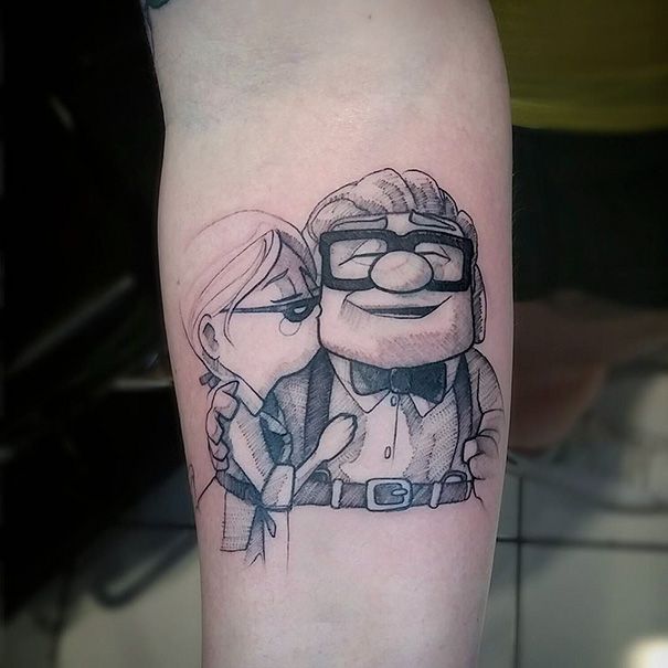 a cartoon character tattoo on the arm of a person with glasses and a tie, next to another character