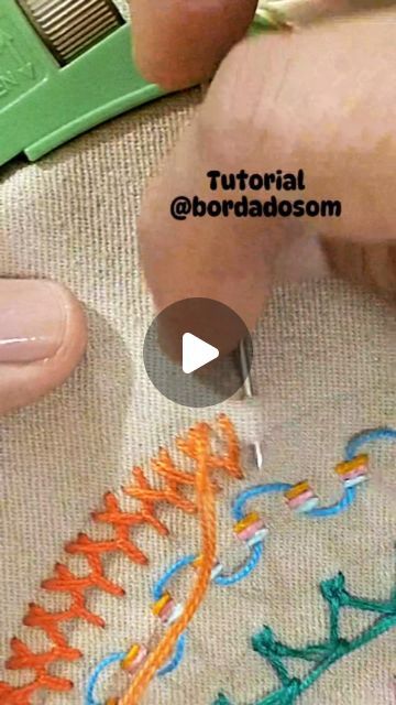 someone is stitching something on a piece of fabric