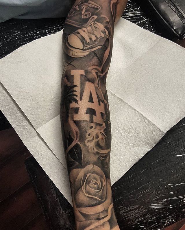 a man's arm with tattoos on it