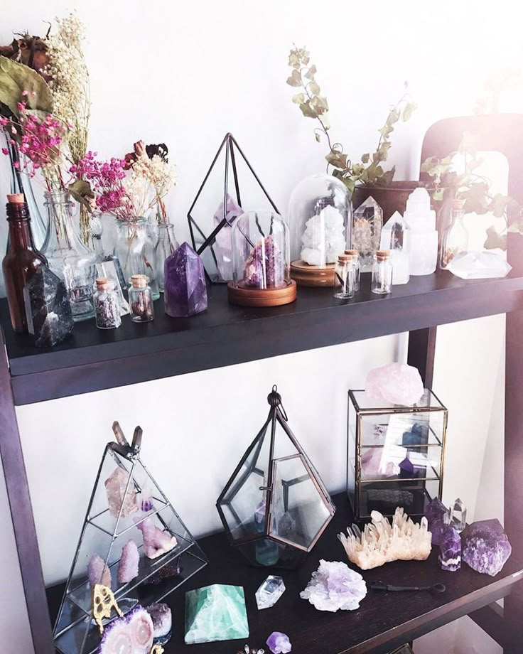 a shelf filled with lots of different types of rocks and crystals on top of it