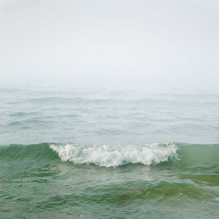 a person riding a surfboard on top of a wave in the ocean