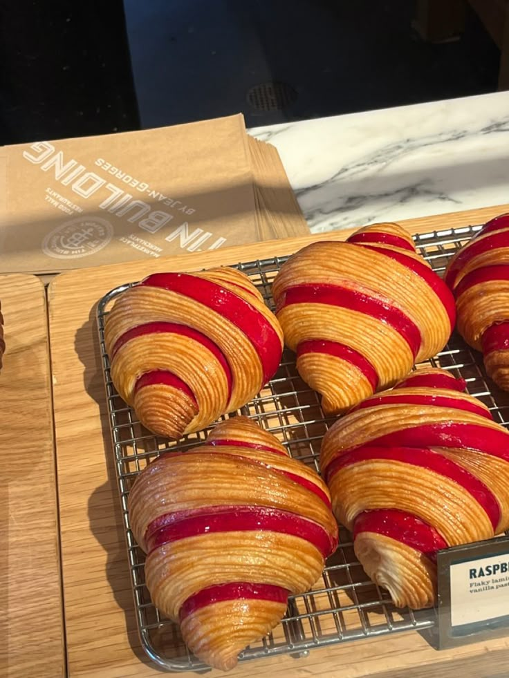 there are many croissants that are on the rack together and ready to be eaten