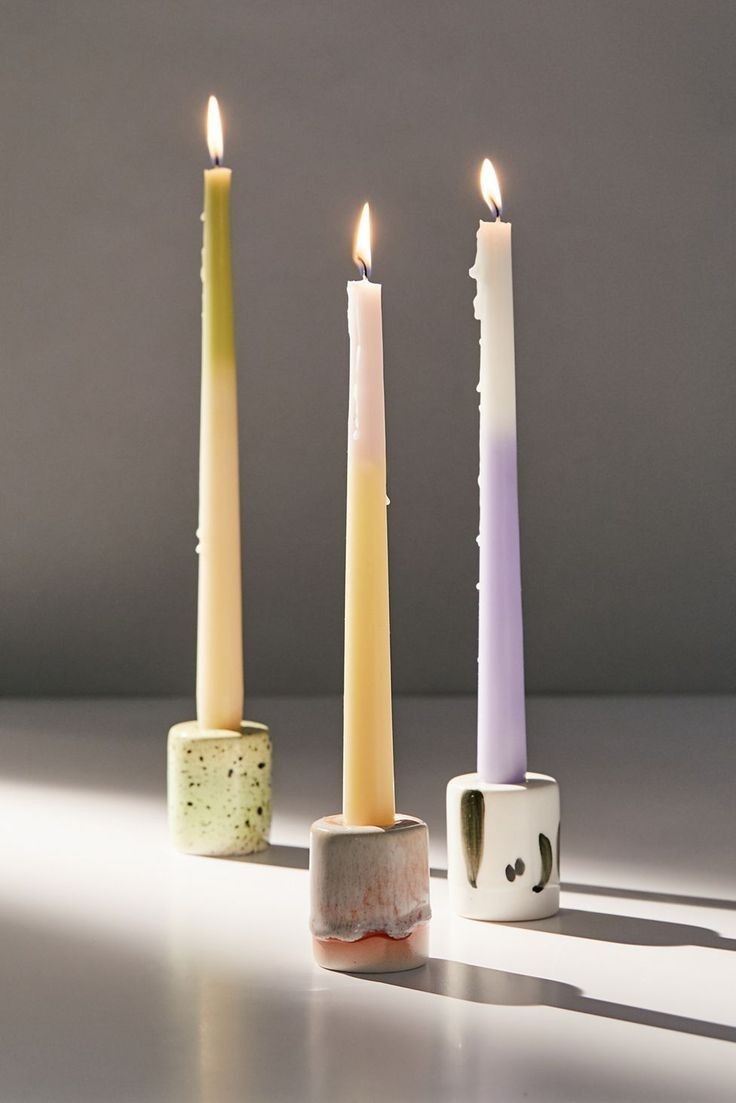 three candles sitting next to each other on a table