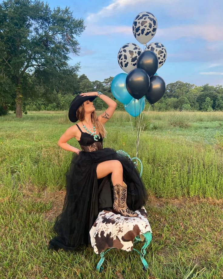 a woman sitting on top of a cowgirl chair with balloons in the air behind her