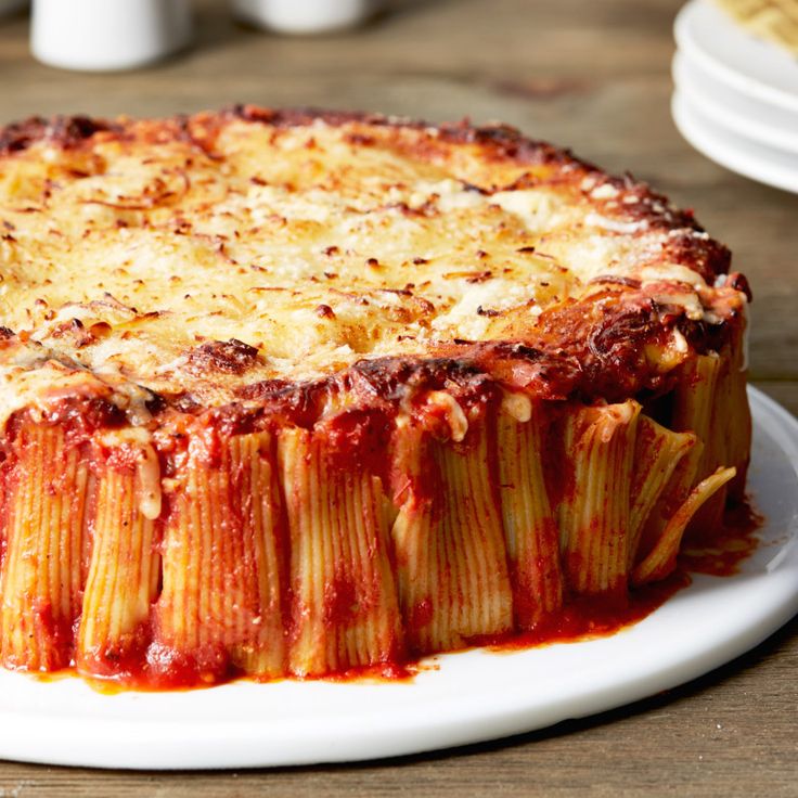 a pasta dish with sauce and cheese on a plate