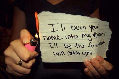 a person holding a piece of paper that says i'll burn your name into my fridge