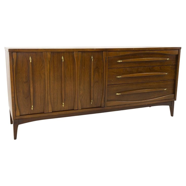 a wooden sideboard with brass handles and drawers