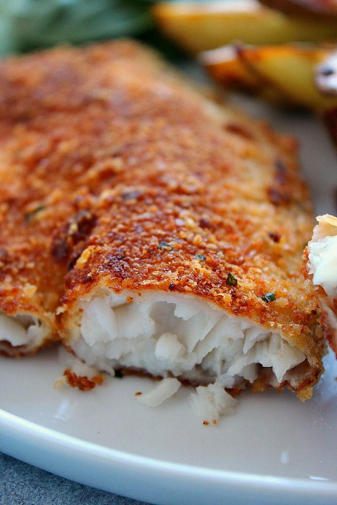 a close up of a plate of food with meat and cheese on it's side