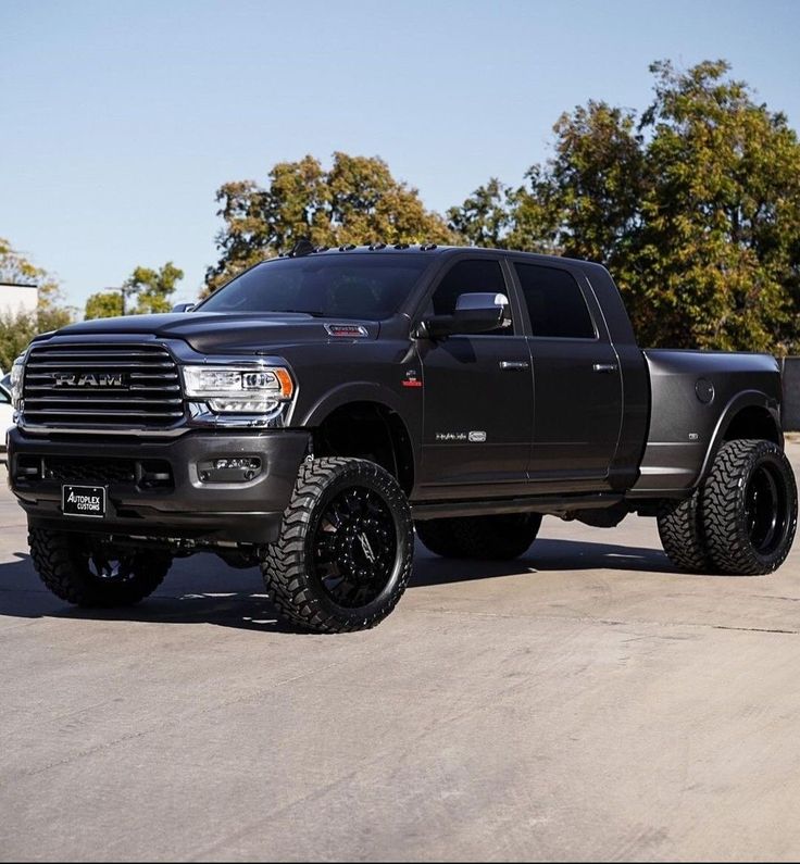 a large black truck parked in a parking lot