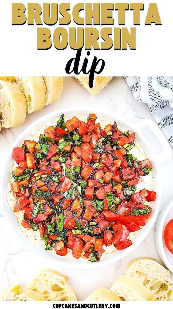 a white bowl filled with tomatoes and spinach on top of a table next to bread