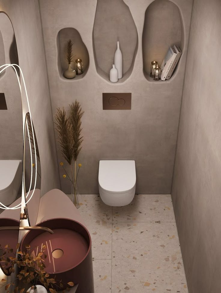 a bathroom with a toilet, sink and mirror on the wall next to each other