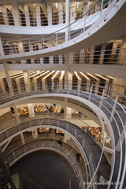 an overhead view of a library with many bookshelves and people walking through them