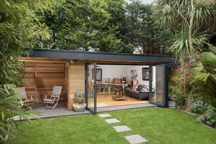 a modern garden room with sliding glass doors