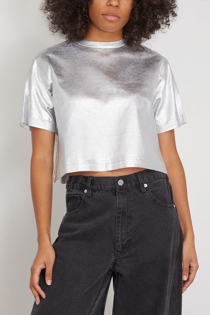 The Simkhai Label Tee in Silver Foil is a twist on a classic. This t-shirt features a cropped, boxy silhouette in a bold metallic silver. Wear yours with high rise jeans and heels. Fits true to size, take your normal size T-shirt Cropped length Boxy silhouette Metallic threading Drop shoulders 93% cotton, 7% elastane with 98% cotton, 2% elastane Celeste is wearing a size XS Bust: 35" Waist: 25.5" Hips: 33" Height: 5’10” Silver Crop Top, Embroidery Coat, Diy Fashion Projects, Rainbow Fish, Suede Mini Skirt, American Fashion Designers, Tank Top Designs, Silver Foil, High Rise Jeans