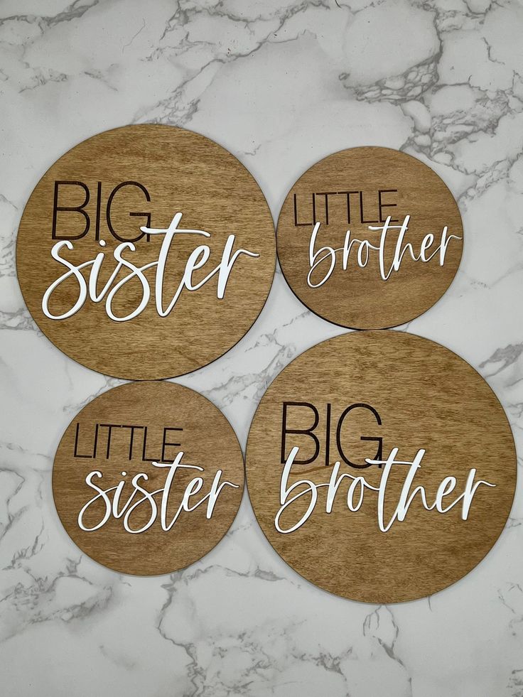 four wooden coasters with the words big sister, little sister and little brother written on them