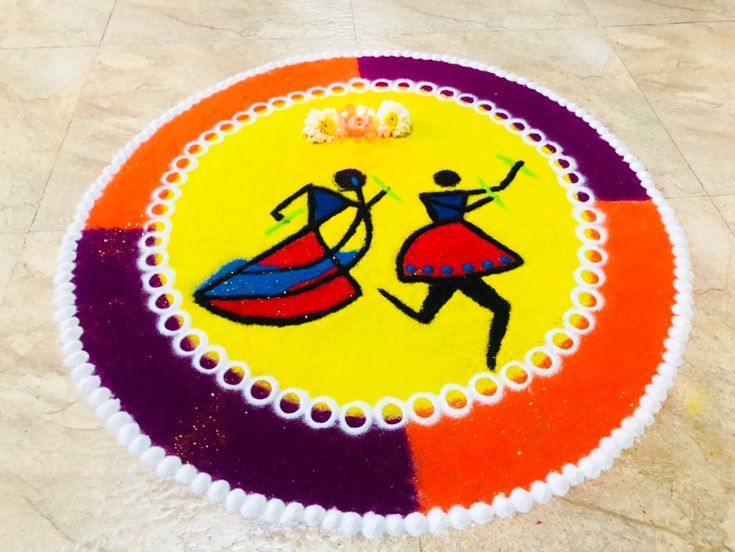 a colorful cake decorated with two people carrying a surfboard