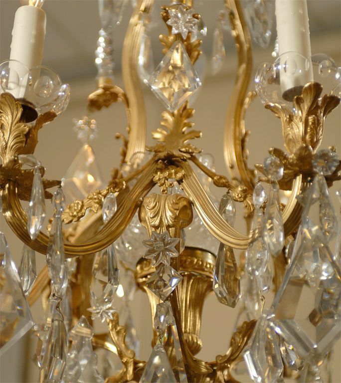 a gold chandelier with two white candles