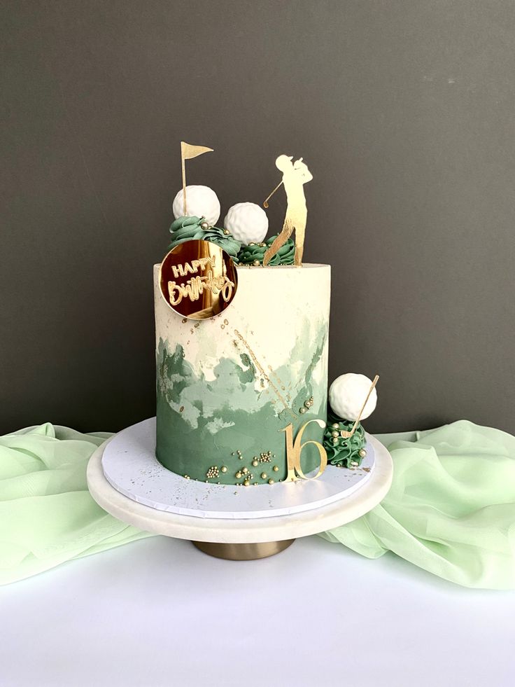 a green and white cake sitting on top of a table