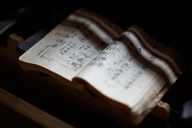 an open book sitting on top of a wooden box