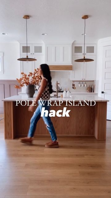 a woman walking through a kitchen with the words pole wrap island hack in front of her