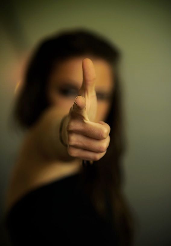 a woman pointing her finger at the camera