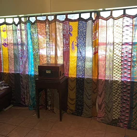 a room that has many different colored curtains on the wall