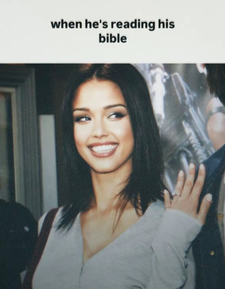 a woman is smiling and holding her hand up to the camera with an ad in front of her that reads, when he's reading his bible