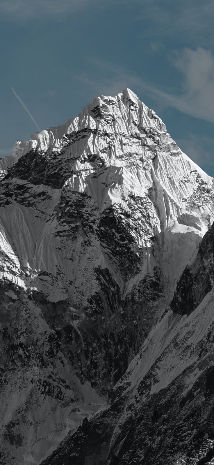 the top of a snow covered mountain in black and white