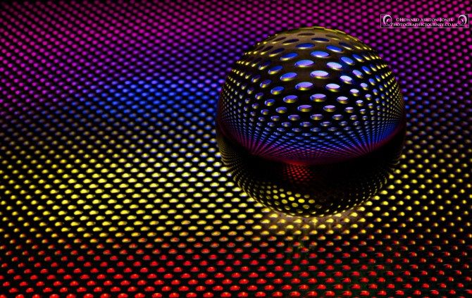 an abstract image of a sphere with dots on it and the colors are multicolored