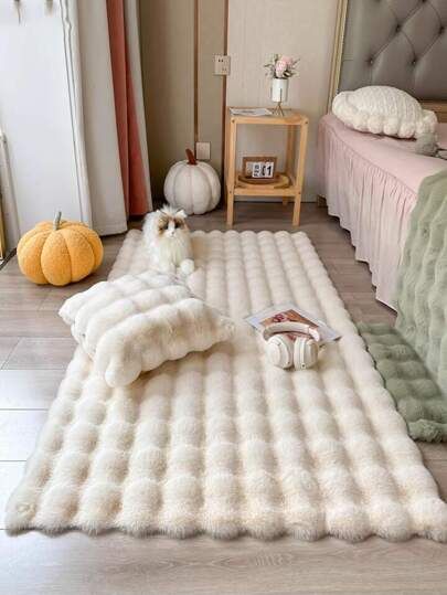 a bed room with two beds and a rug on the floor in front of it