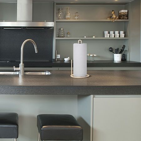 a kitchen counter with two stools next to it and an oven in the background