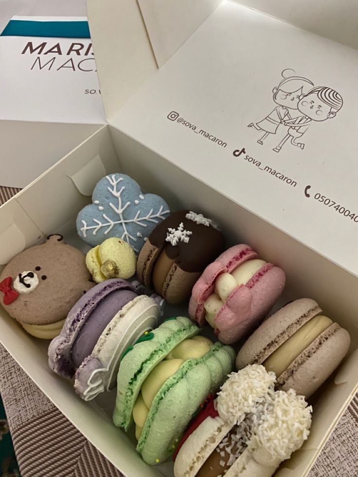 a box filled with lots of different colored macaroons