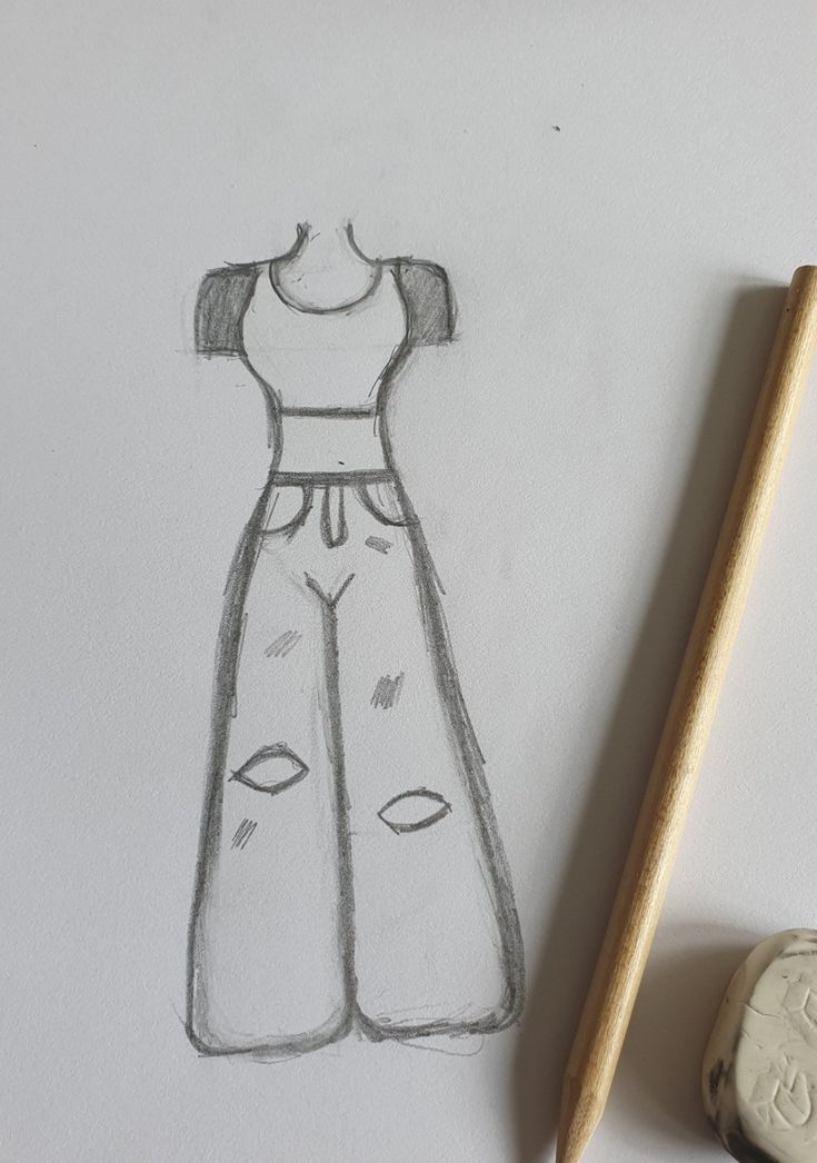 a pencil drawing of a dress on a paper next to a marker and eraser