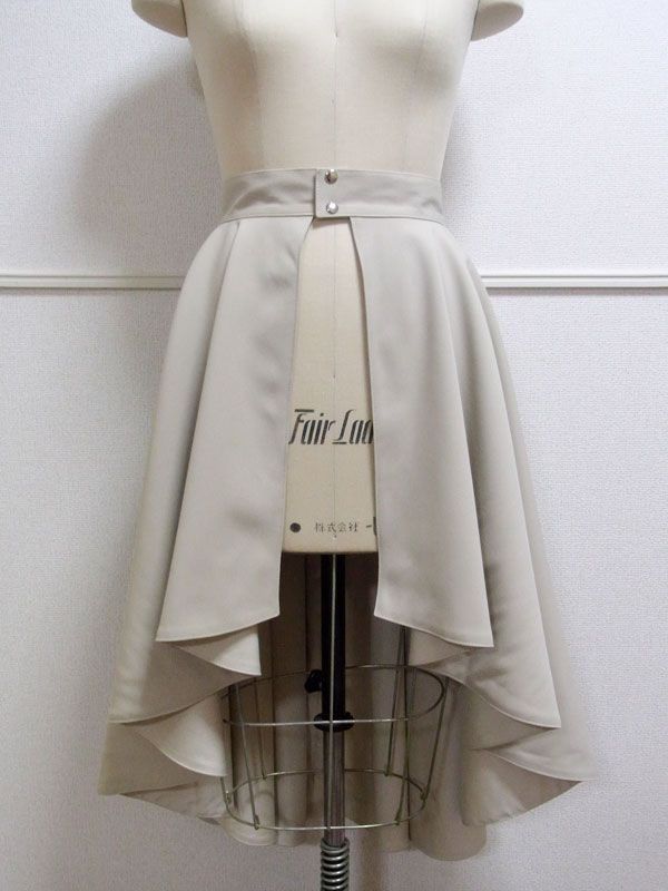 a white dress with a belt is on a mannequin