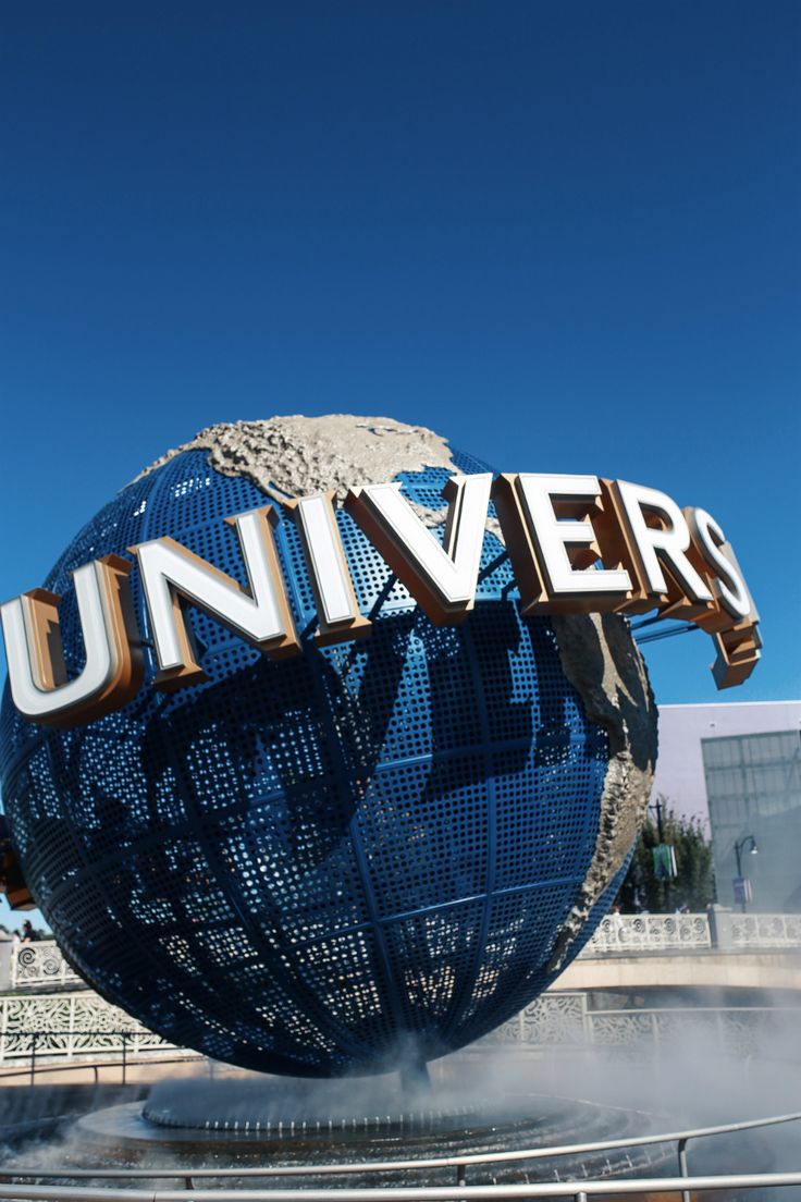 a large sign that says universal on top of a blue globe