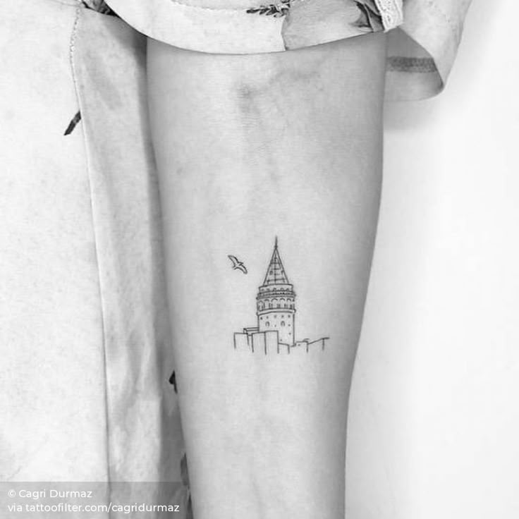 a black and white photo of a person with a small tattoo on their leg