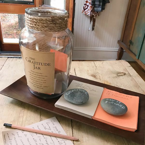 there is a jar with some writing on it next to two rocks and a pen