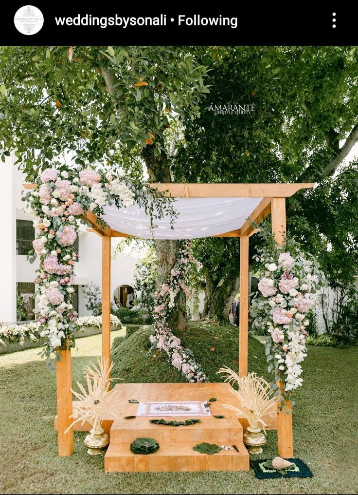 an outdoor ceremony setup with flowers and greenery