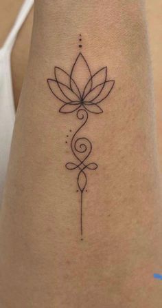 a woman's foot with a tattoo on it that has a flower in the middle