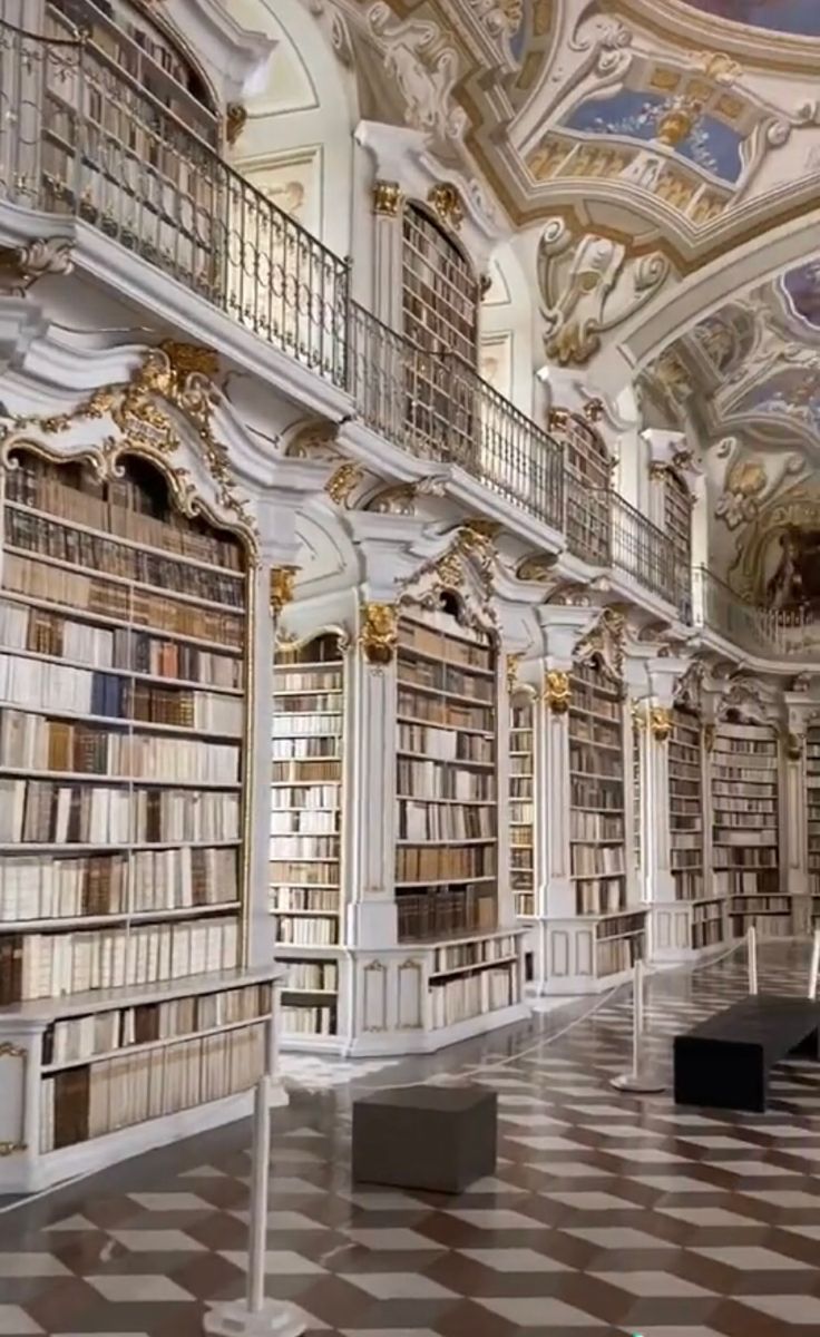 an empty library with many bookshelves filled with lots of books on the walls