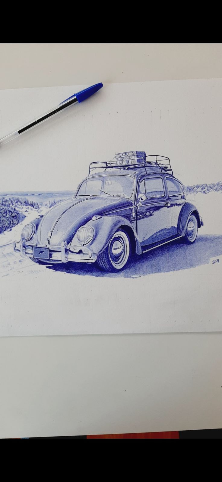 a drawing of a blue car with luggage on the roof is next to a brush