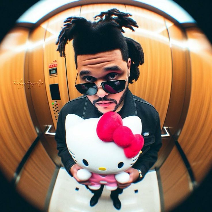 a man holding a hello kitty stuffed animal